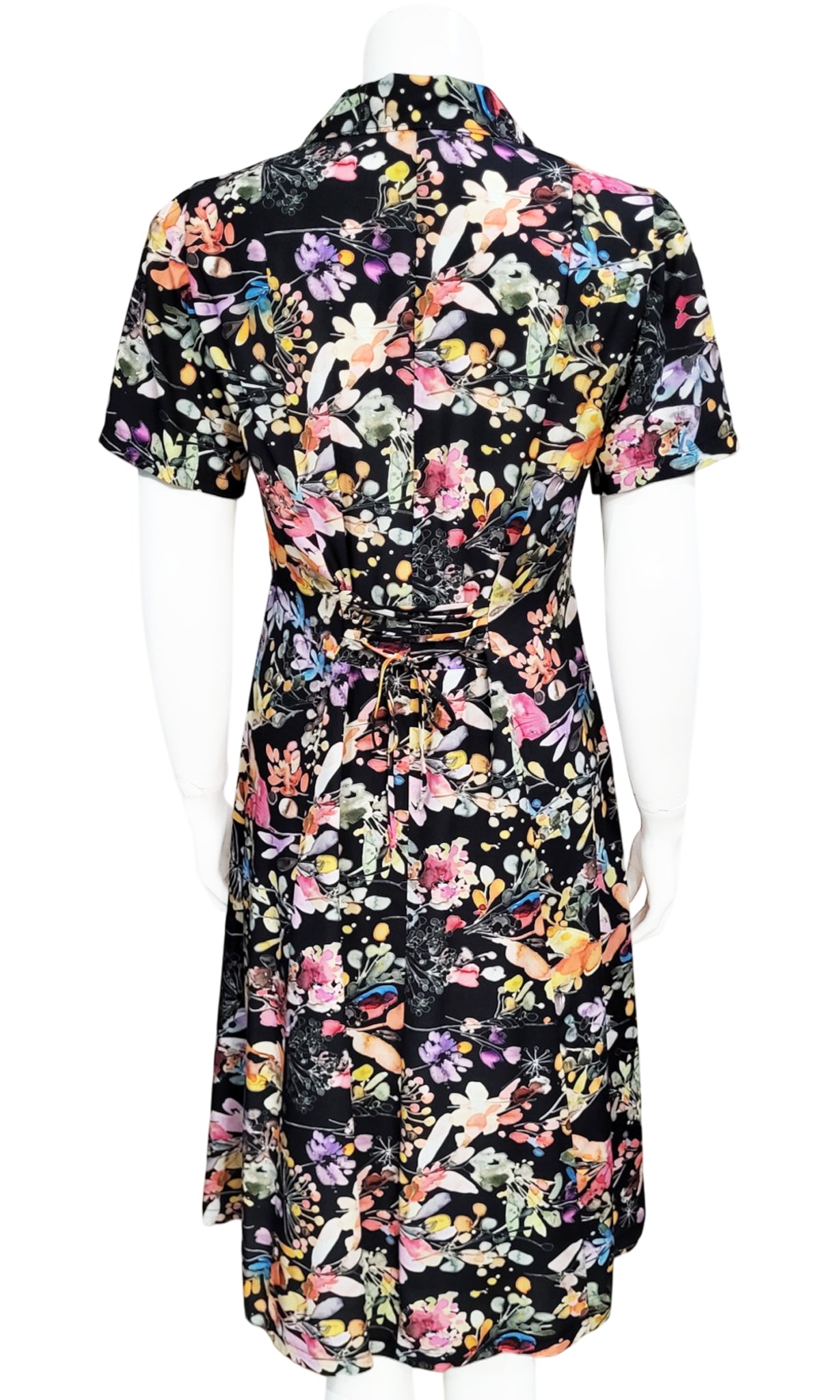 A short-sleeve dress with a multicolor floral print on a black background, displayed on a white mannequin against a white background.